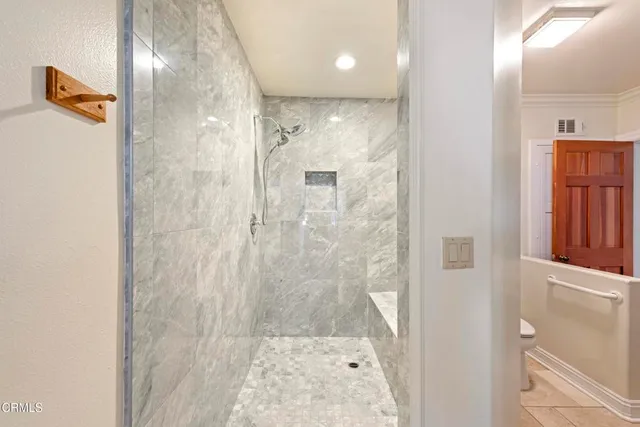 a bathroom with a glass shower door