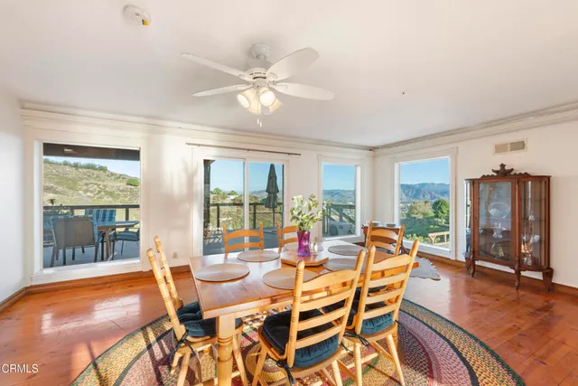 a dining room with furniture window and wooden floor