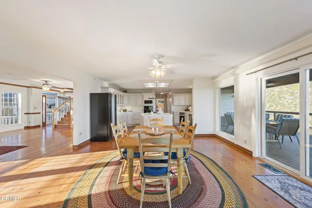 a view of a dining room with furniture wooden floor and a chandelier