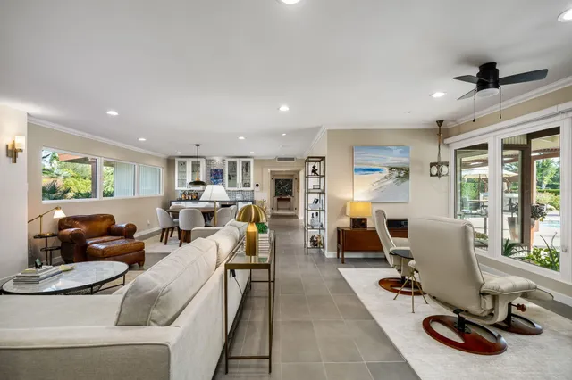 a view of a dining room with furniture and chandelier