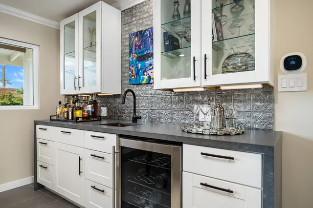 a living room with large window and furniture