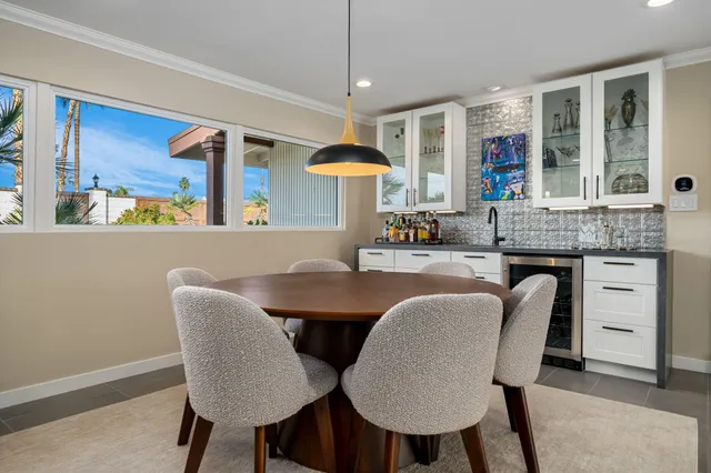 a bedroom with a bed and a dresser next to a window