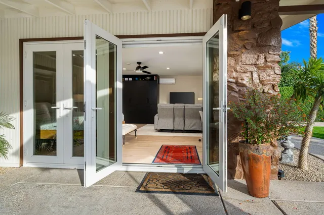 a view of a house with swimming pool and sitting area