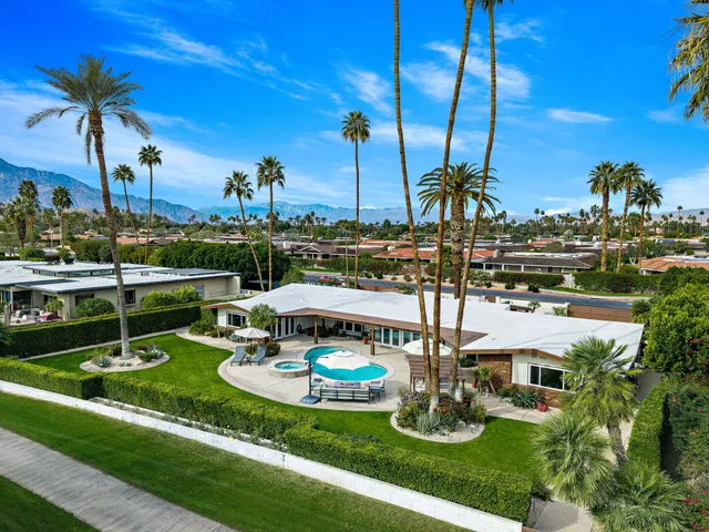 an aerial view of a house with a swimming pool