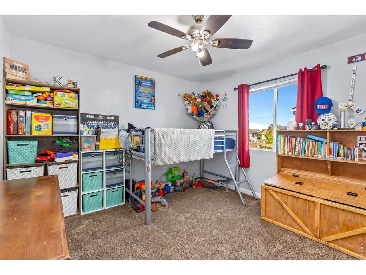 233 East 19th Street Road Greeley, CO 80631 - Photo 12 of 22 a children room with toys and a flat screen tv