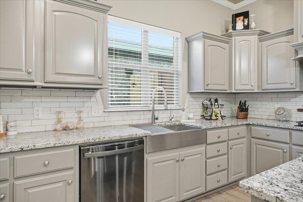 7612 59th Street Lubbock, TX 79407 - Photo 11 of 42 a kitchen with granite countertop cabinets sink and window