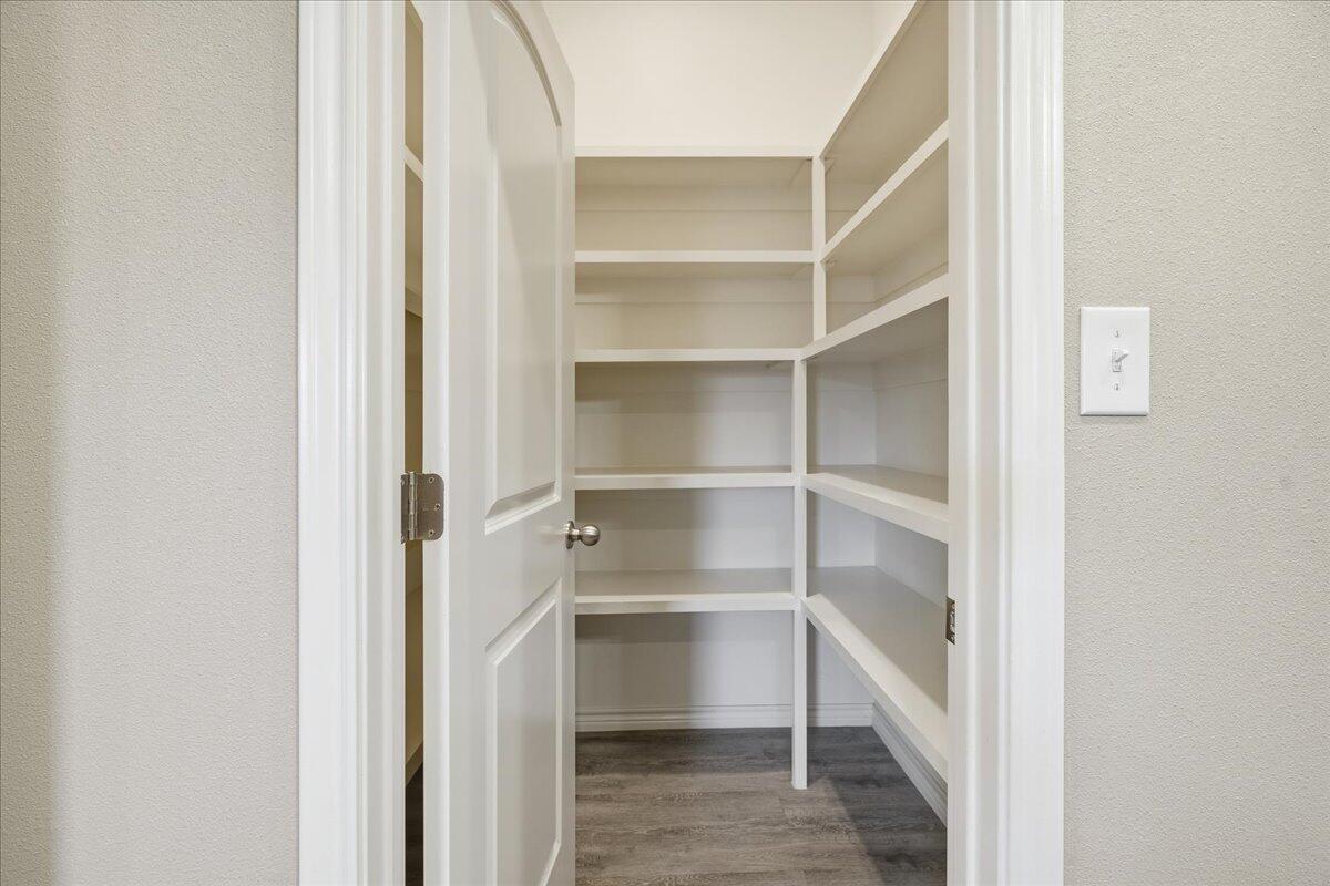 7612 59th Street Lubbock, TX 79407 - Photo 15 of 42 a view of walk in closet with empty racks