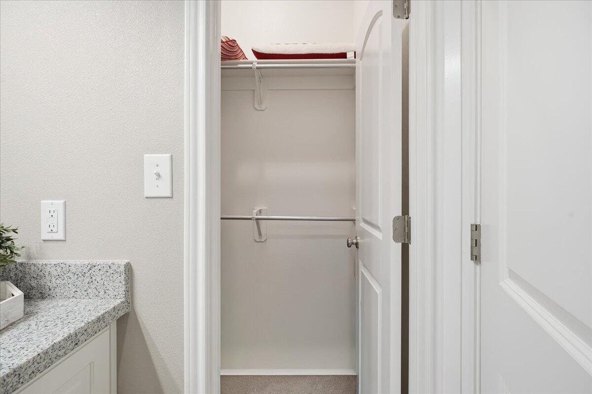 7612 59th Street Lubbock, TX 79407 - Photo 22 of 42 a bathroom with a granite countertop shower and a sink