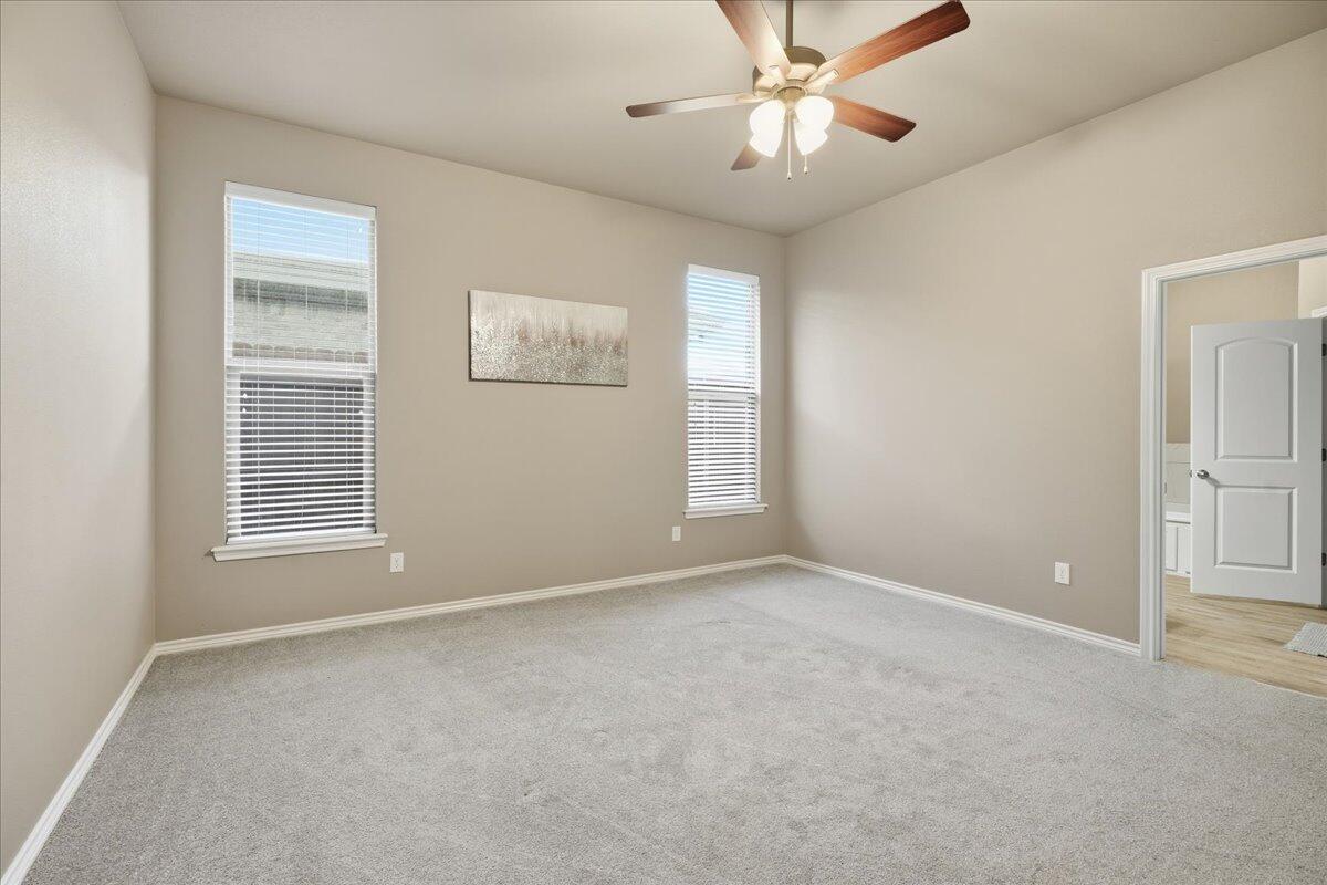 7612 59th Street Lubbock, TX 79407 - Photo 23 of 42 an empty room with windows and fan