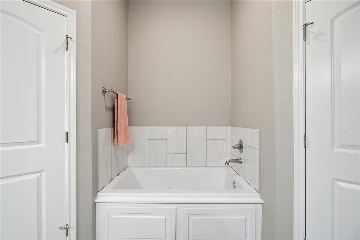 7612 59th Street Lubbock, TX 79407 - Photo 28 of 42 a bathroom with a sink and mirror