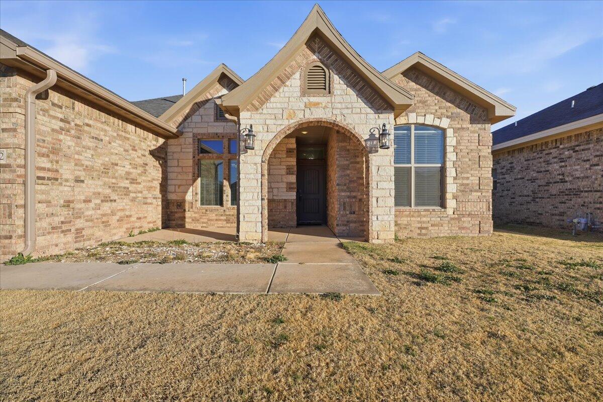 7612 59th Street Lubbock, TX 79407 - Photo 3 of 42 a view of a house with a yard and garage