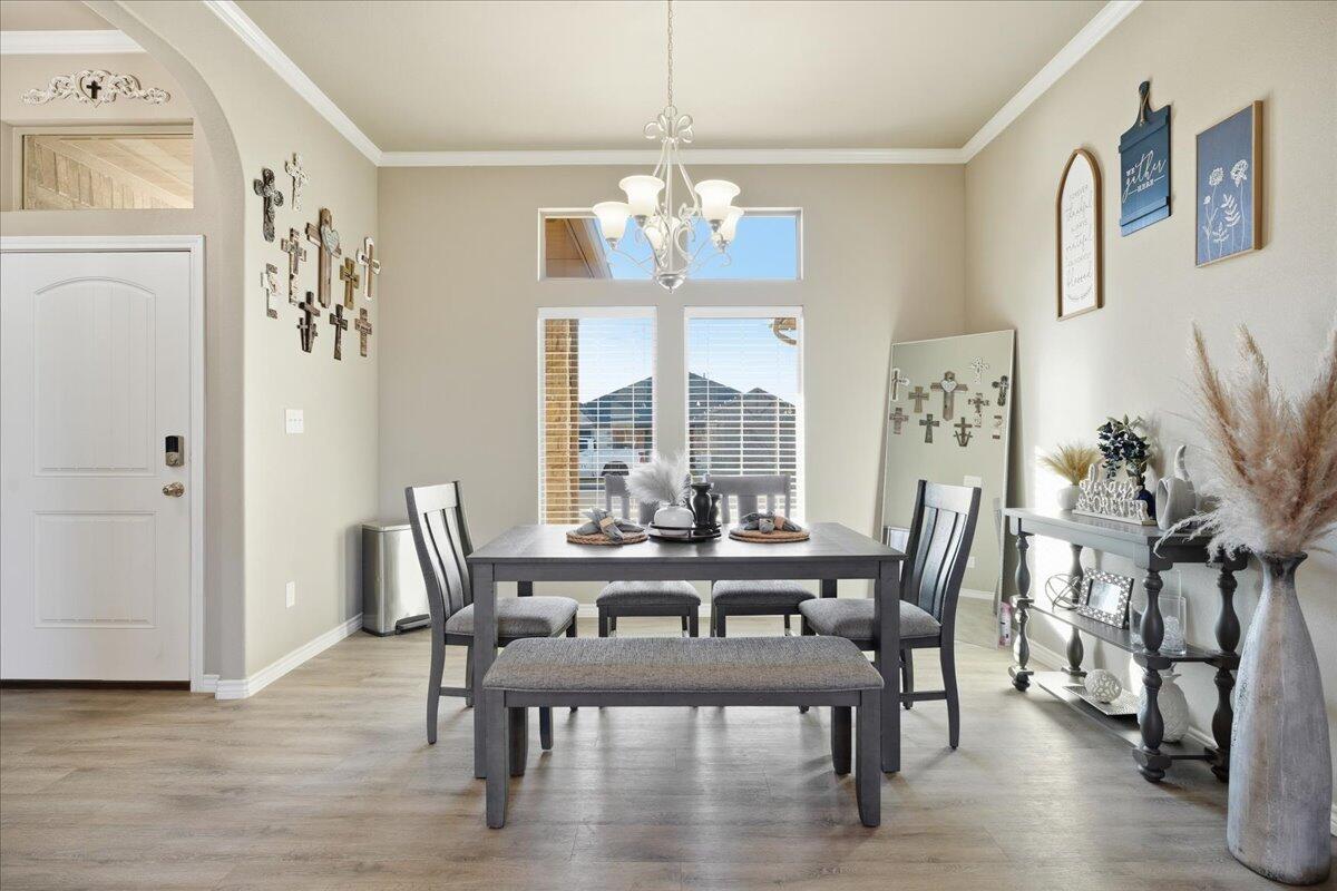 7612 59th Street Lubbock, TX 79407 - Photo 8 of 42 a view of a dining room with furniture window and wooden floor