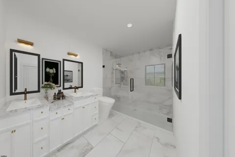 a bathroom with a granite countertop sink mirror and bathtub