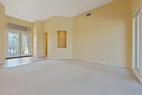 an empty room with windows and closet
