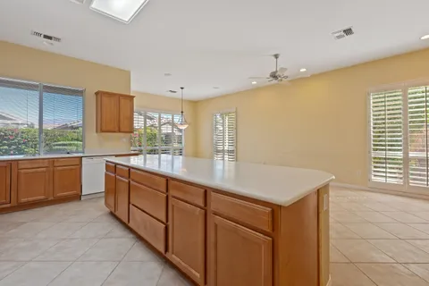 a kitchen with stainless steel appliances granite countertop a sink and a wooden cabinets
