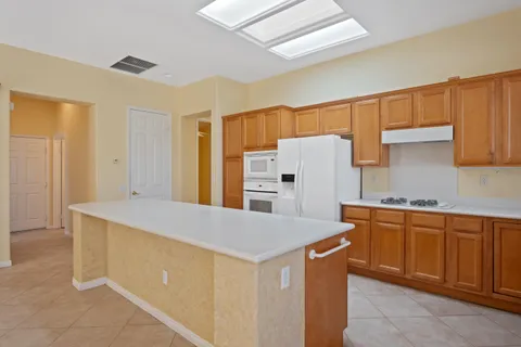 a kitchen with stainless steel appliances a refrigerator and a stove