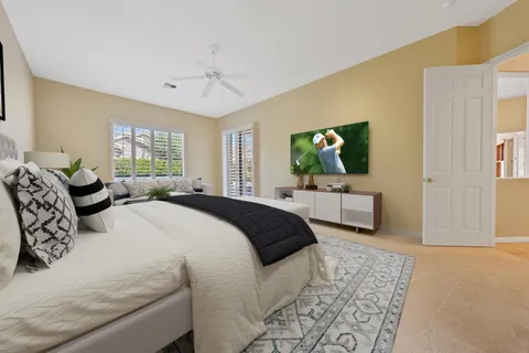 a bedroom with a large bed and a couch