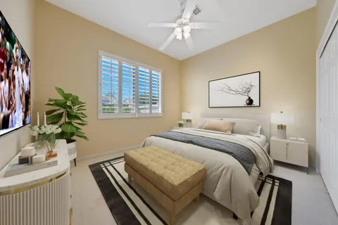 a bedroom with a large bed and a chandelier