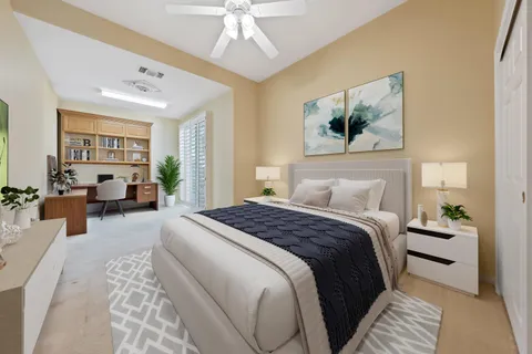 a spacious bedroom with a large bed and a chandelier