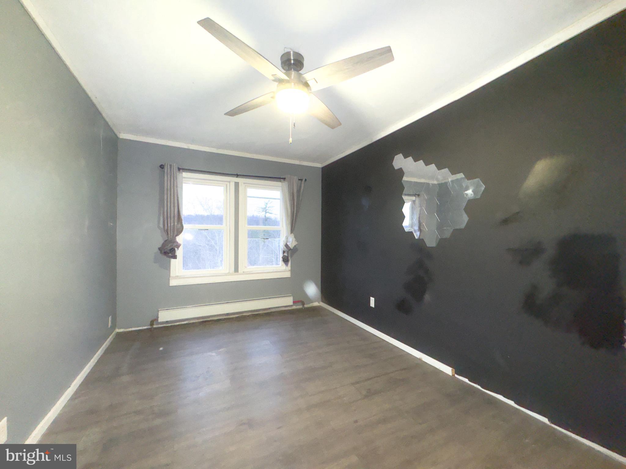 3709 Highway 522 Lewistown, PA 17044 - Photo 24 of 28 an empty room with chandelier fan and windows