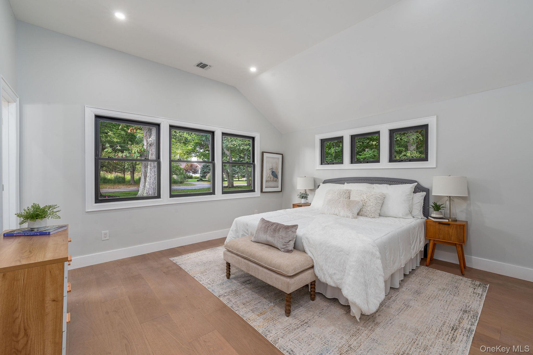 3420 Rocky Point Road East Marion, NY 11939 - Photo 13 of 34 Bedroom featuring vaulted ceiling, recessed lighting, and wood finished floors