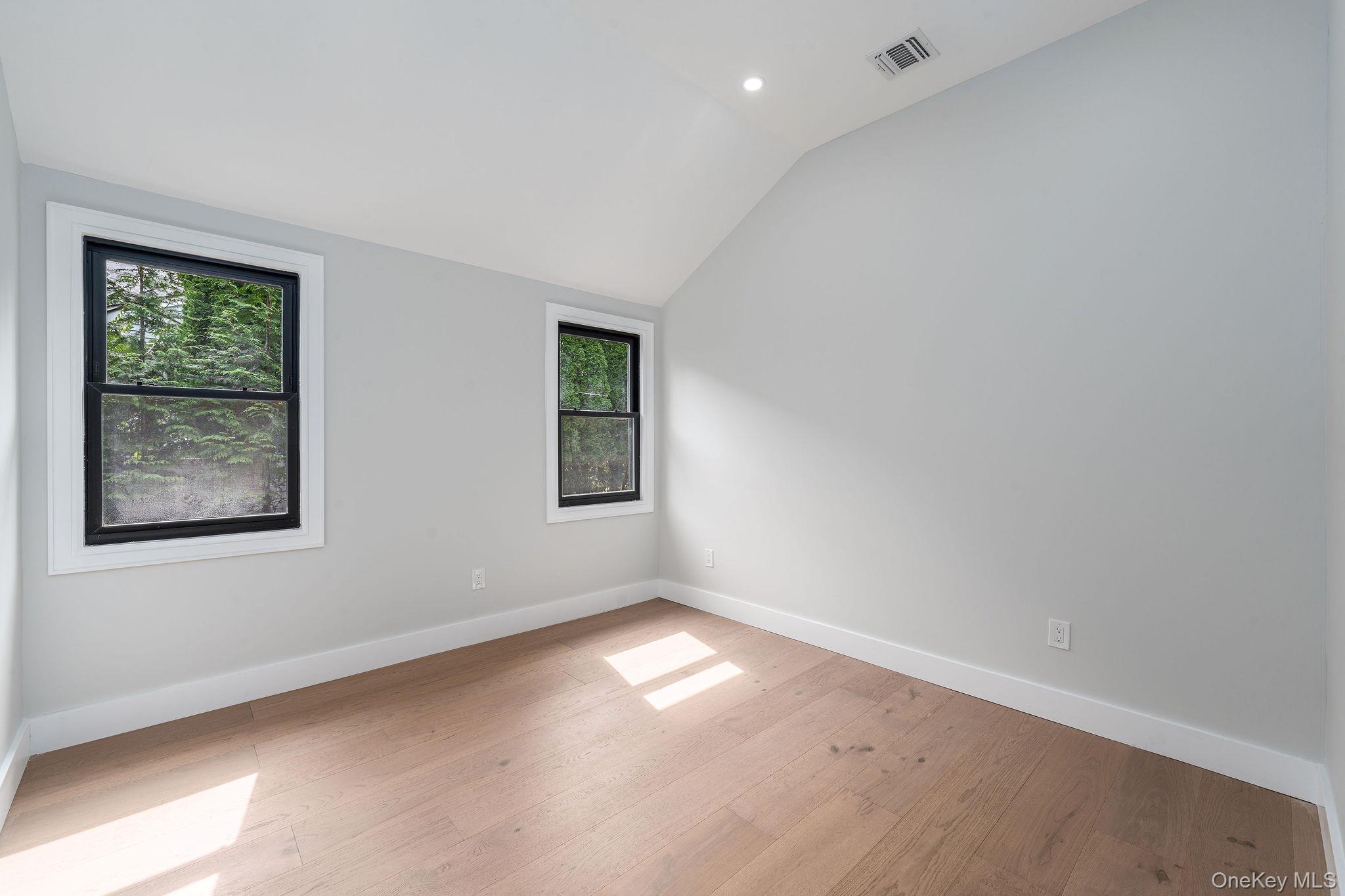 3420 Rocky Point Road East Marion, NY 11939 - Photo 19 of 34 Spare room with lofted ceiling, light wood finished floors, and recessed lighting