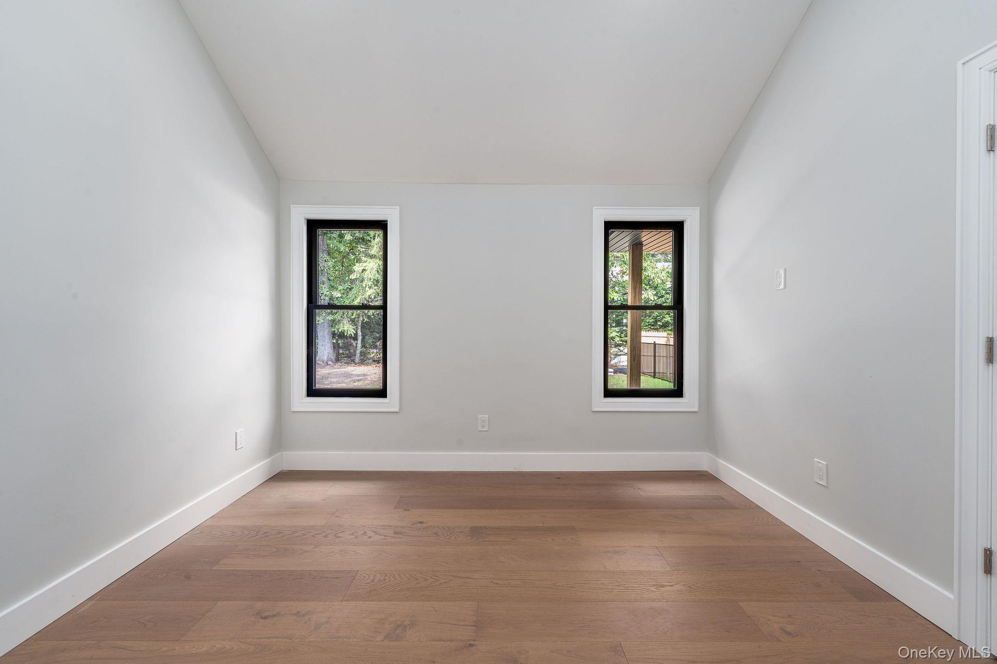 3420 Rocky Point Road East Marion, NY 11939 - Photo 20 of 34 Unfurnished room with wood-type flooring, healthy amount of natural light, and lofted ceiling