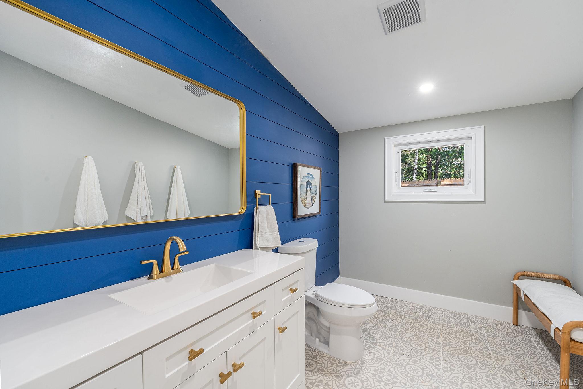 3420 Rocky Point Road East Marion, NY 11939 - Photo 25 of 34 Bathroom with vanity, lofted ceiling, wood walls, and recessed lighting