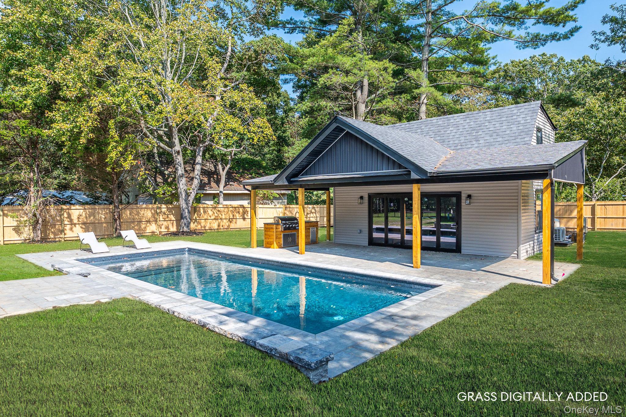 3420 Rocky Point Road East Marion, NY 11939 - Photo 26 of 34 View of pool featuring a fenced backyard, a patio, view of wooded area, and grilling area