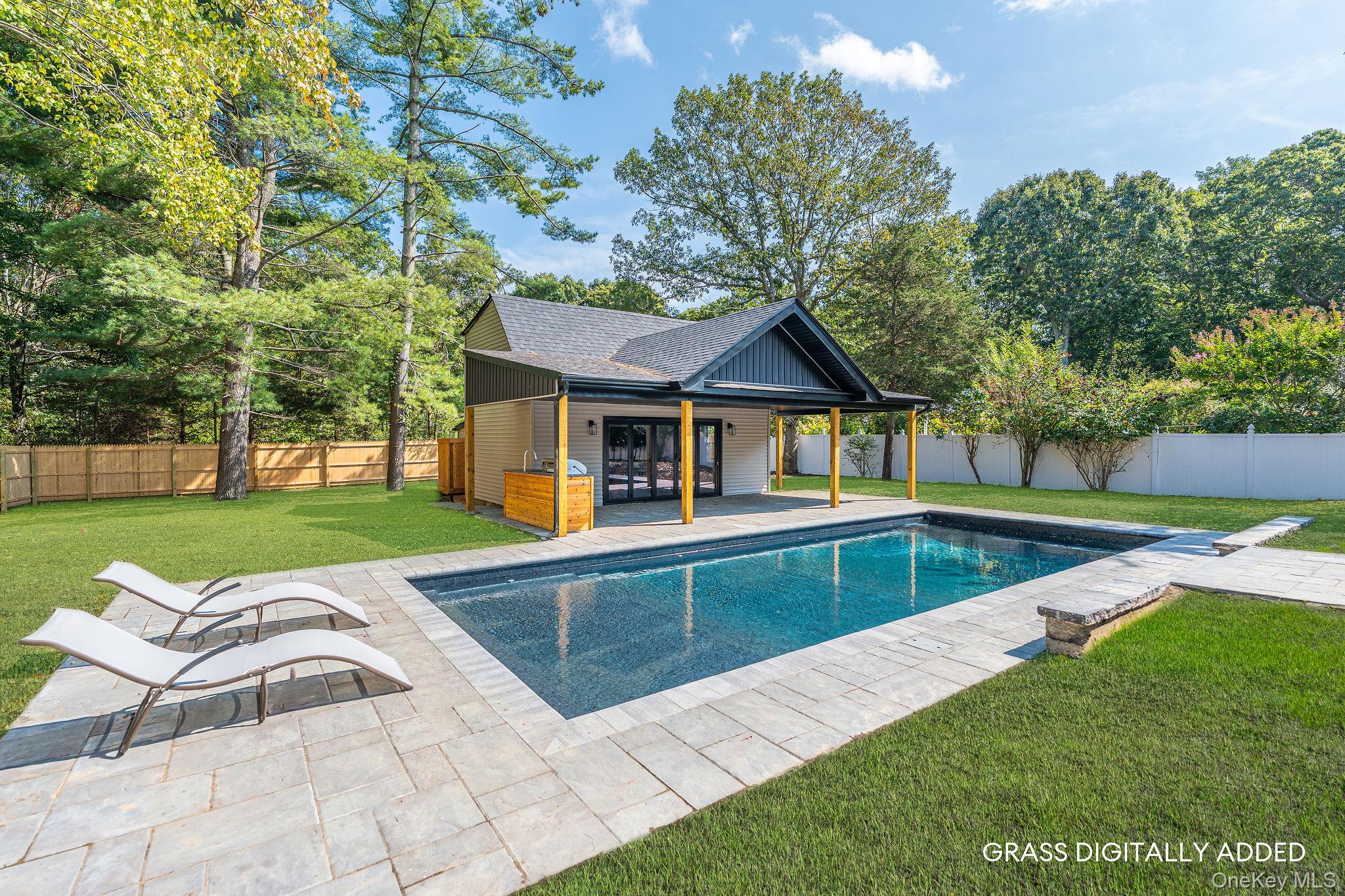 3420 Rocky Point Road East Marion, NY 11939 - Photo 28 of 34 View of swimming pool featuring a patio, a fenced backyard, an exterior structure, an outbuilding, and view of wooded area