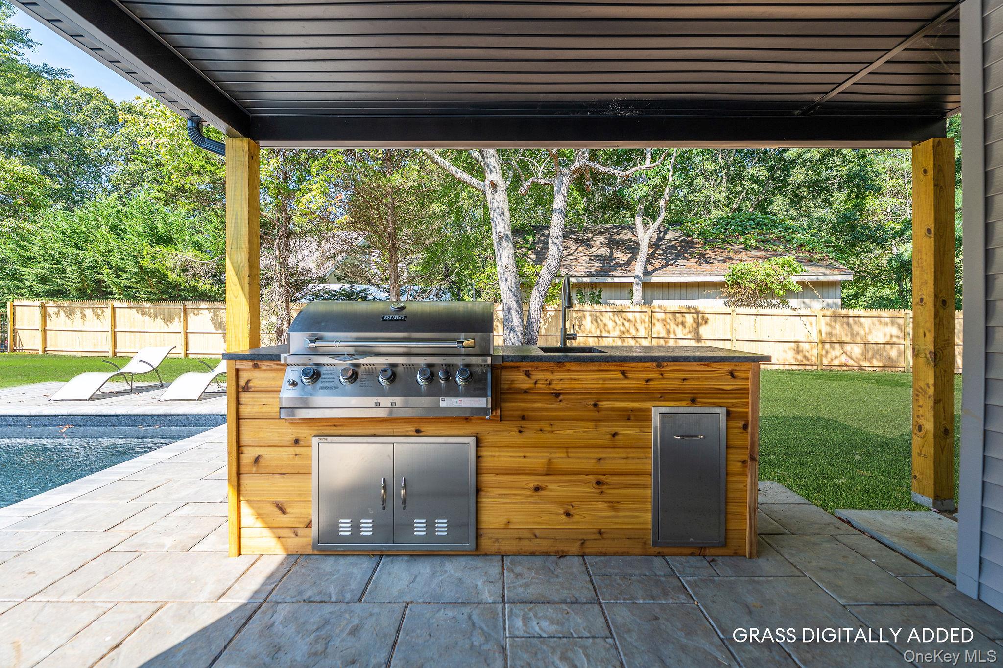 3420 Rocky Point Road East Marion, NY 11939 - Photo 30 of 34 Fenced backyard featuring exterior kitchen and a patio area
