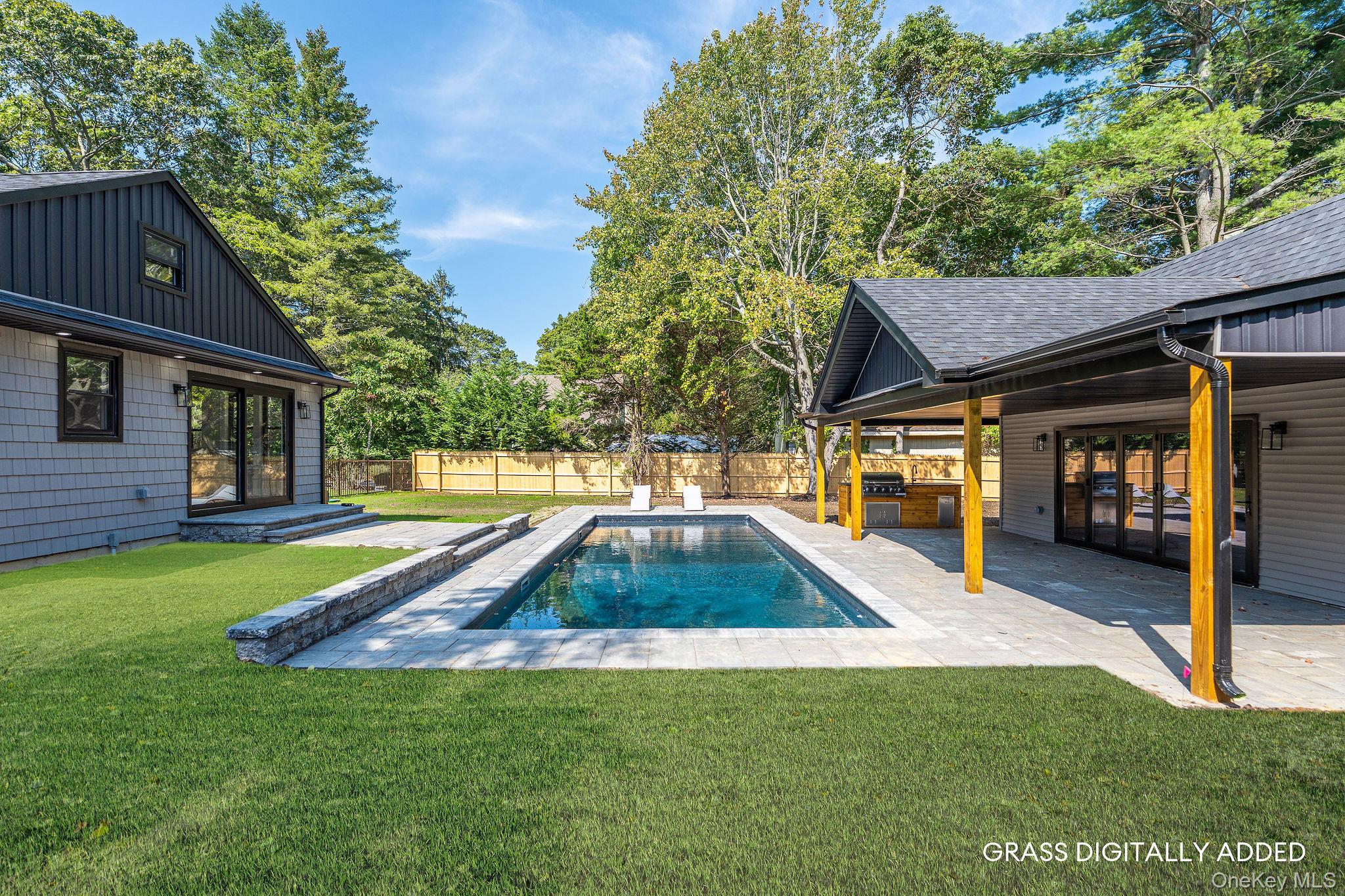 3420 Rocky Point Road East Marion, NY 11939 - Photo 3 of 34 View of swimming pool featuring a fenced backyard, a patio area, exterior kitchen, and view of wooded area