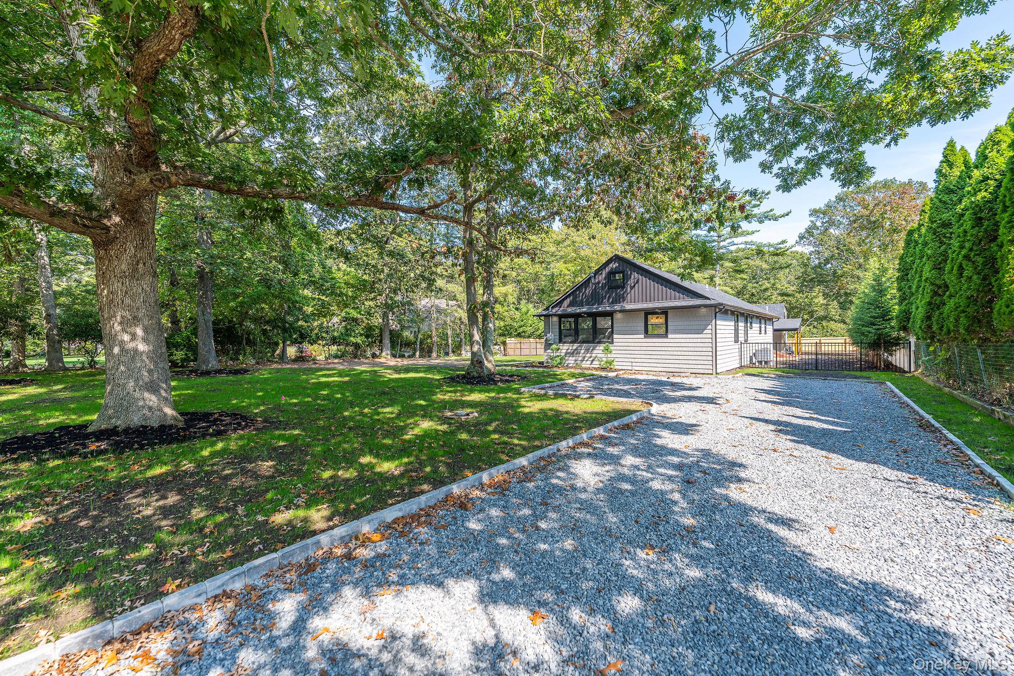 3420 Rocky Point Road East Marion, NY 11939 - Photo 32 of 34 View of front of home with driveway and board and batten siding