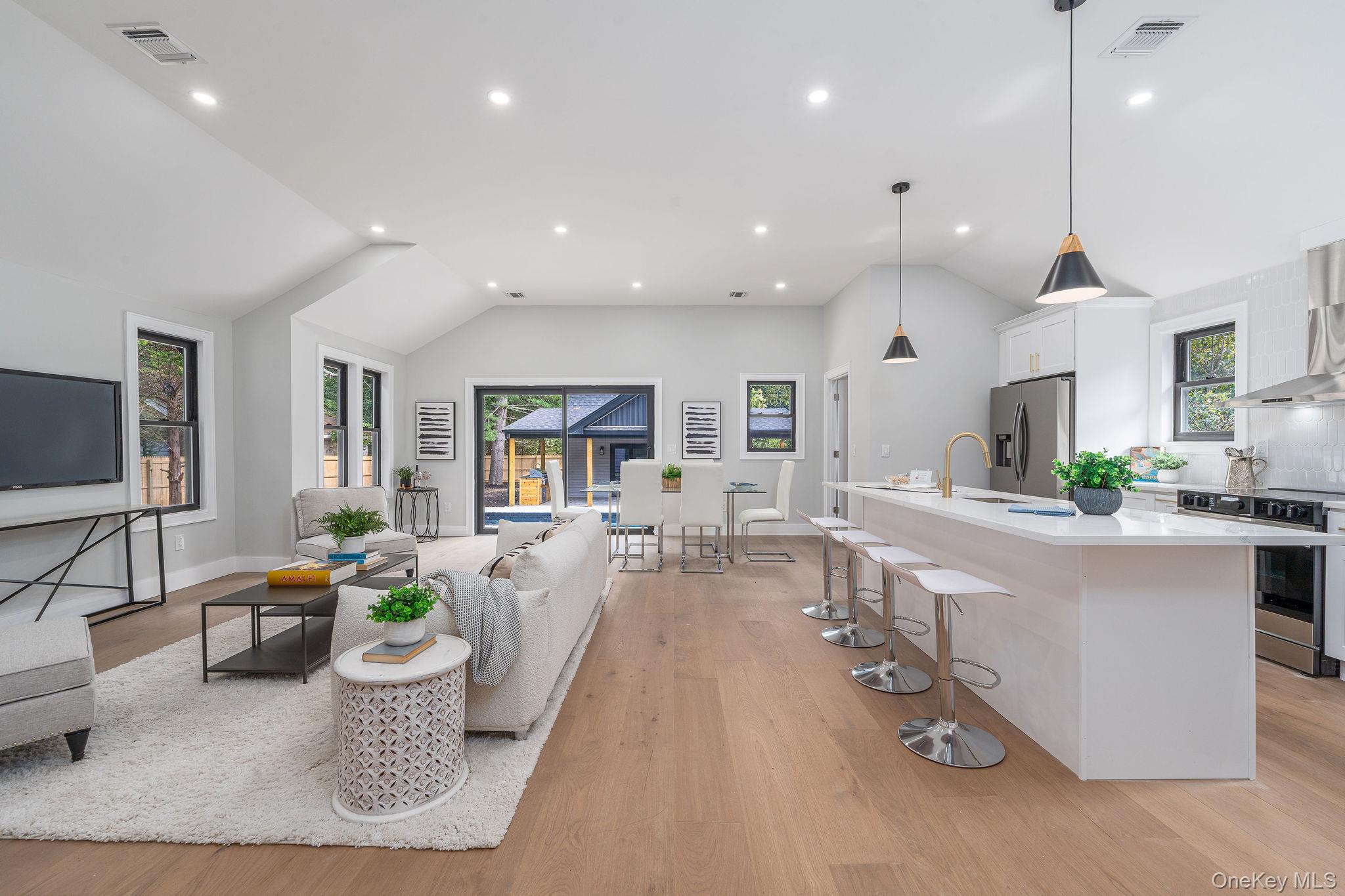 3420 Rocky Point Road East Marion, NY 11939 - Photo 5 of 34 Living area featuring lofted ceiling, recessed lighting, and light wood-style flooring