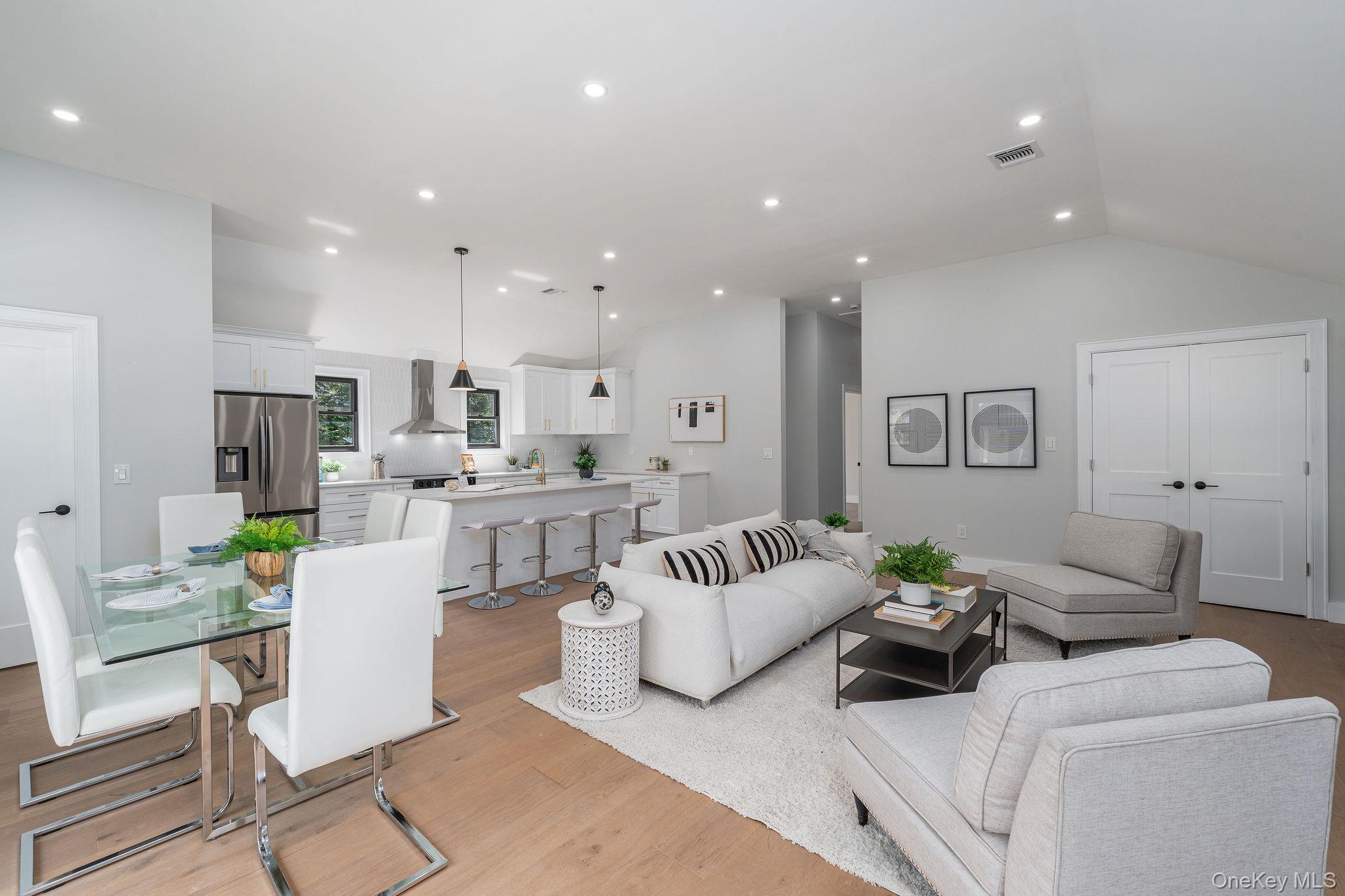 3420 Rocky Point Road East Marion, NY 11939 - Photo 7 of 34 Living area featuring lofted ceiling, light wood finished floors, and recessed lighting