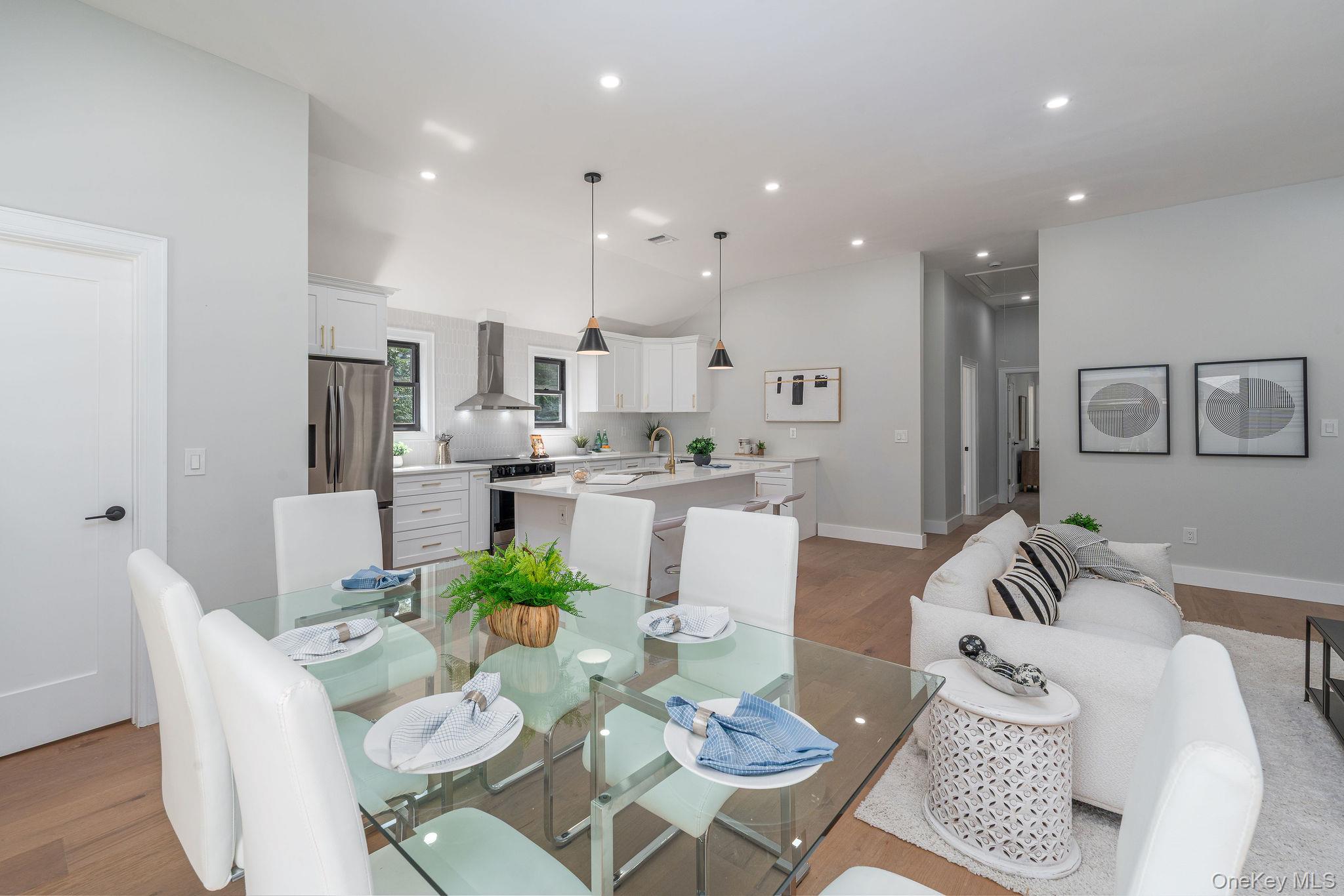 3420 Rocky Point Road East Marion, NY 11939 - Photo 8 of 34 Dining space featuring light wood-style floors, recessed lighting, and lofted ceiling