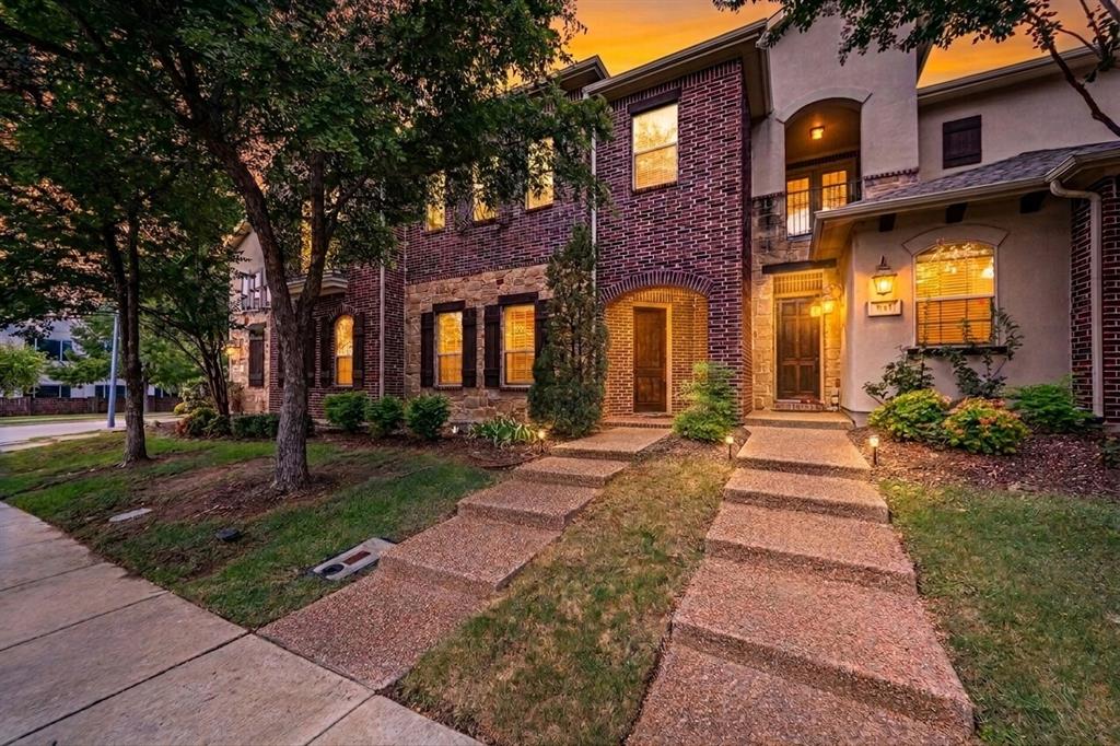 Brick and stucco exterior featuring multiple gables