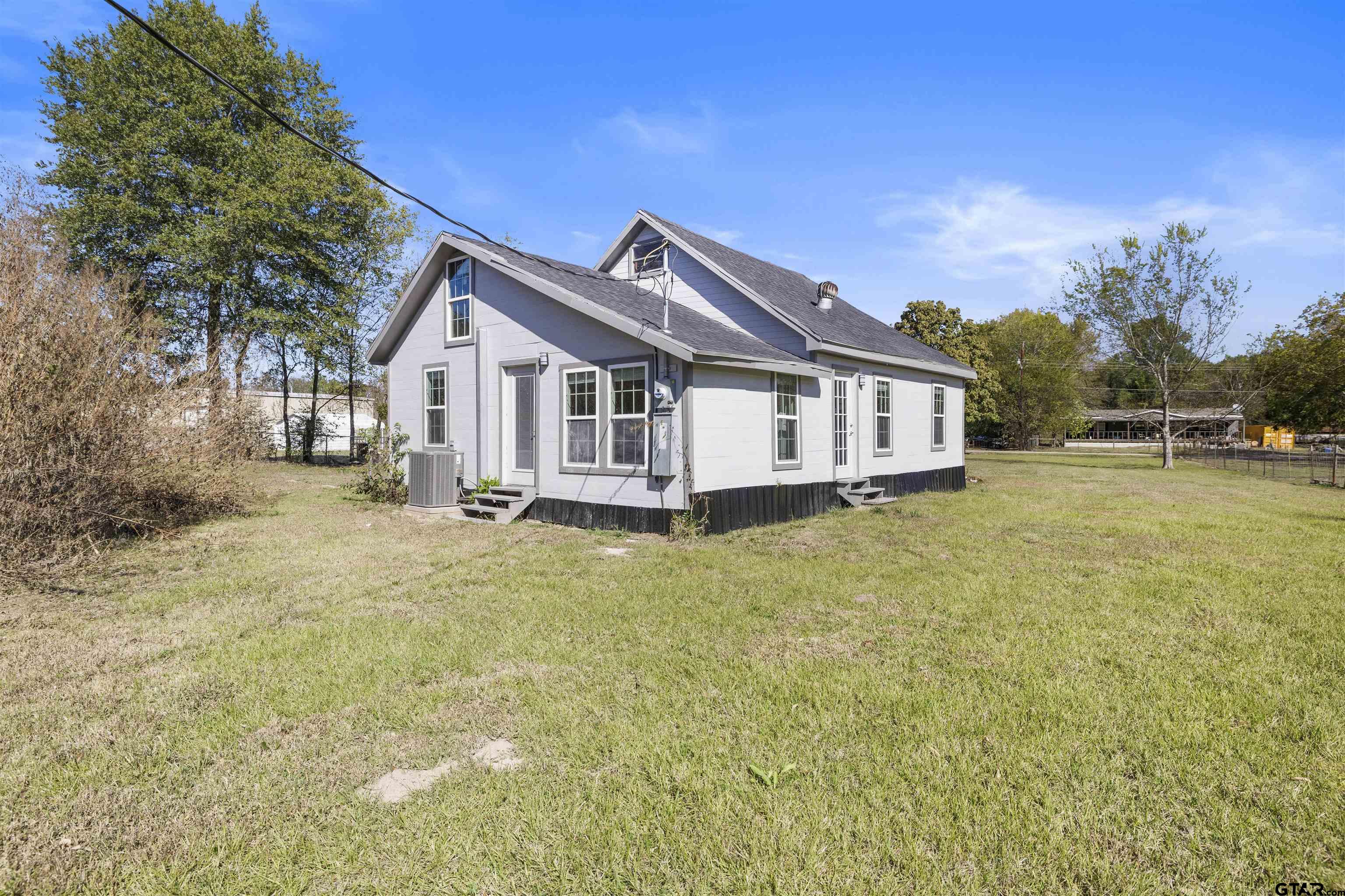 229 Orchard Street Alba, TX 75410 - Photo 3 of 16 a view of a house with a big yard and large trees