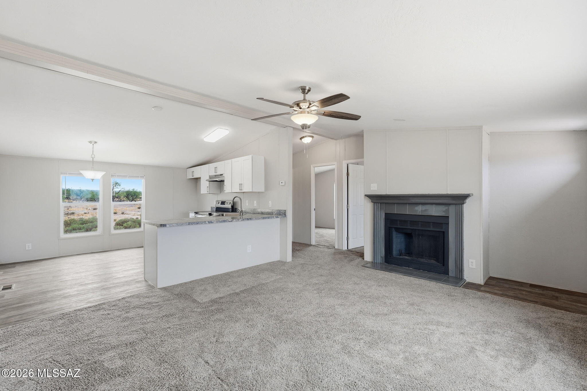 8690 South Marstellar Road Tucson, AZ 85736 - Photo 4 of 51 Open living area with wood burning fireplace