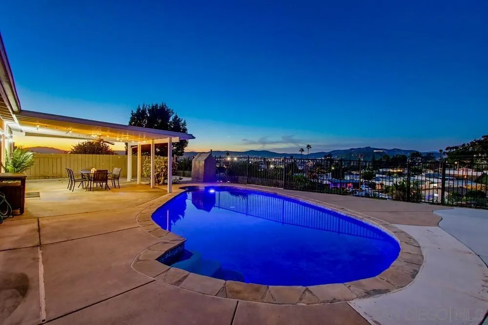 a view of a swimming pool with an outdoor space and seating area