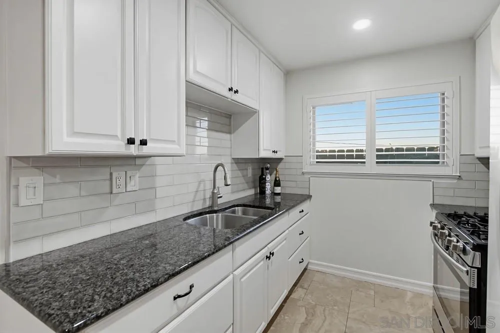 11038 Larkridge Street Santee, CA 92071 - Photo 11 of 44 a kitchen with granite countertop white cabinets and a sink
