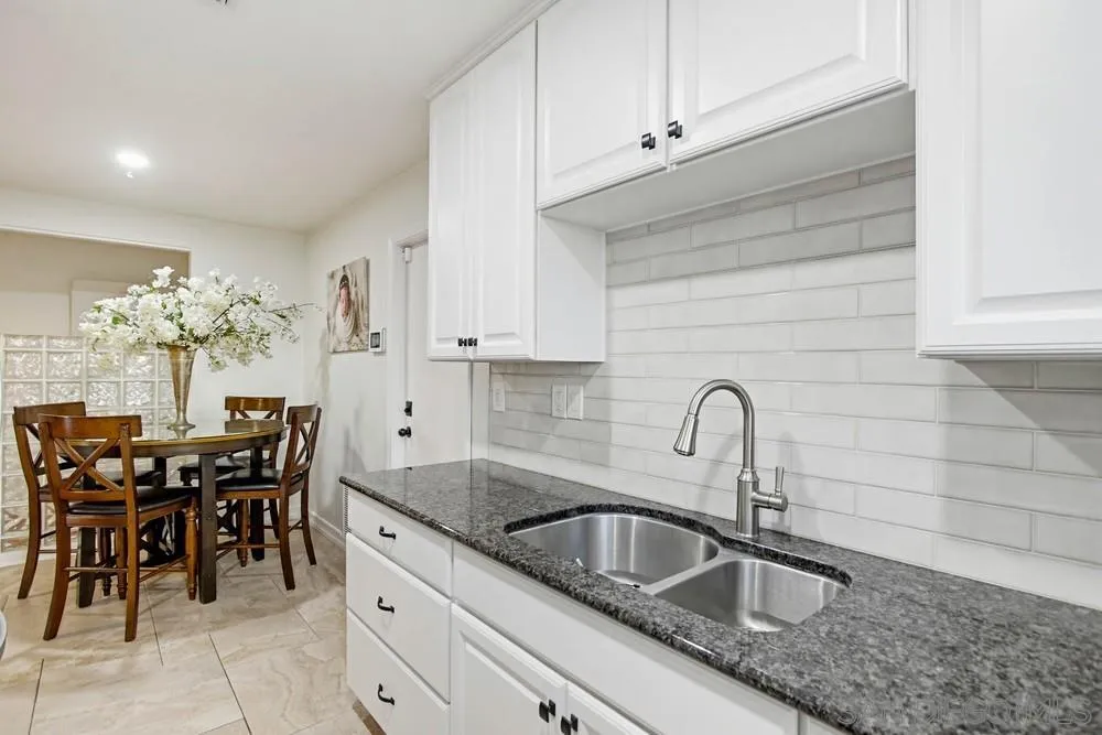 11038 Larkridge Street Santee, CA 92071 - Photo 13 of 44 a kitchen with a sink and cabinets
