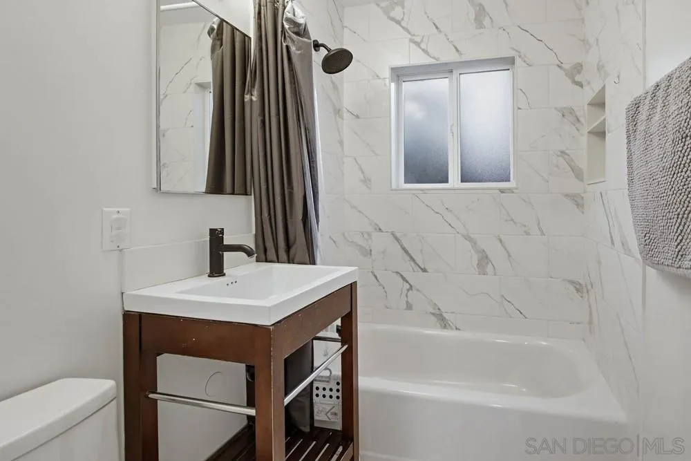 11038 Larkridge Street Santee, CA 92071 - Photo 20 of 44 a bathroom with a sink a toilet and bathtub