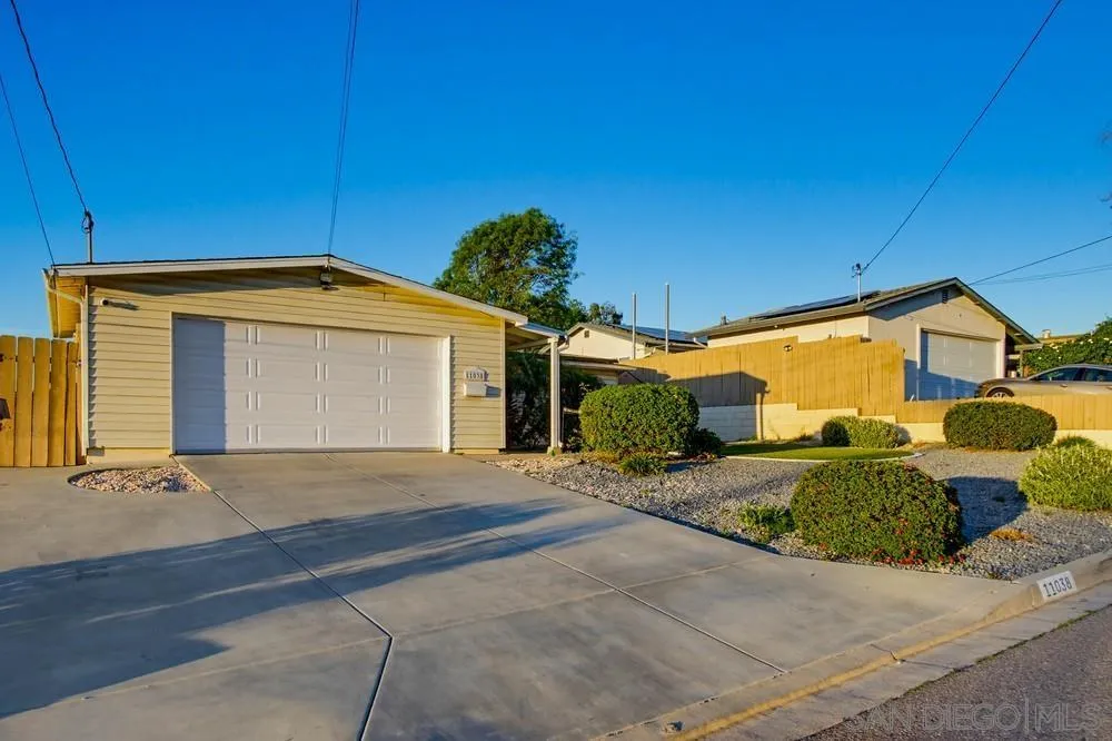 11038 Larkridge Street Santee, CA 92071 - Photo 24 of 44 a front view of a house with a yard and garage
