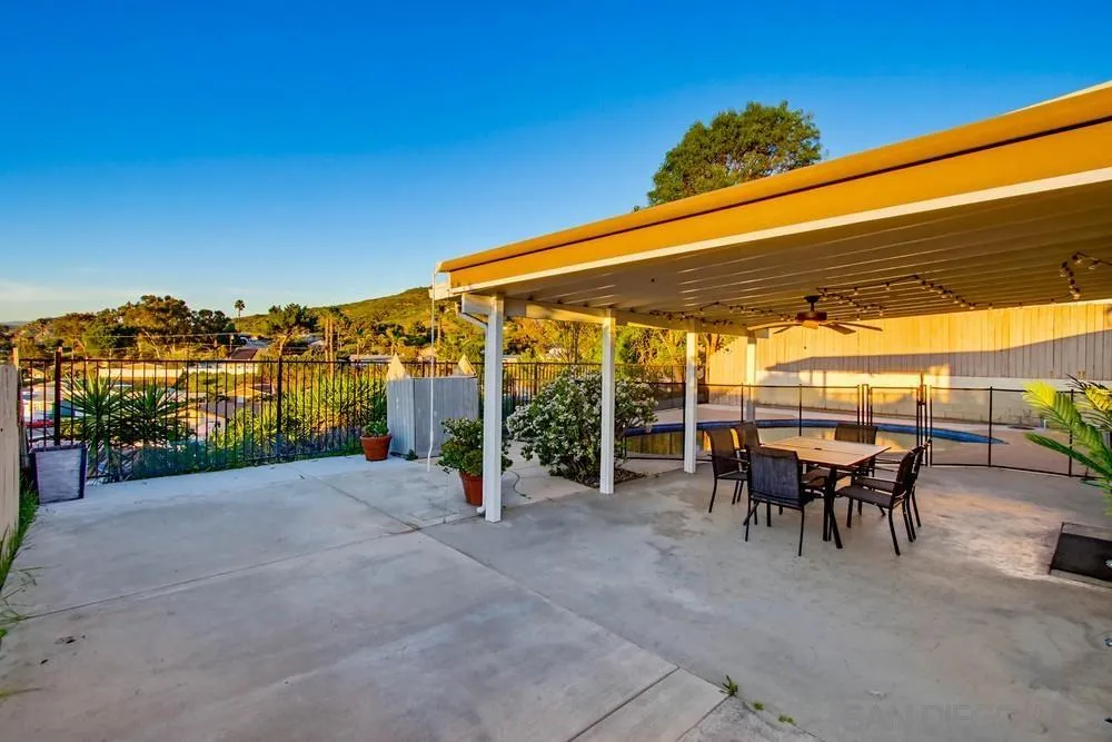 11038 Larkridge Street Santee, CA 92071 - Photo 34 of 44 a view of a patio with a table and chairs under an umbrella
