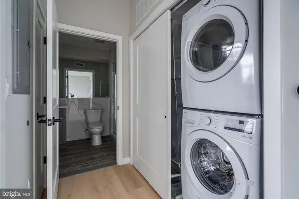 a view of a hallway with washer and dryer