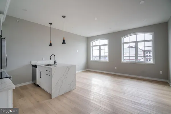 a view of a kitchen with sink dishwasher and wooden floor