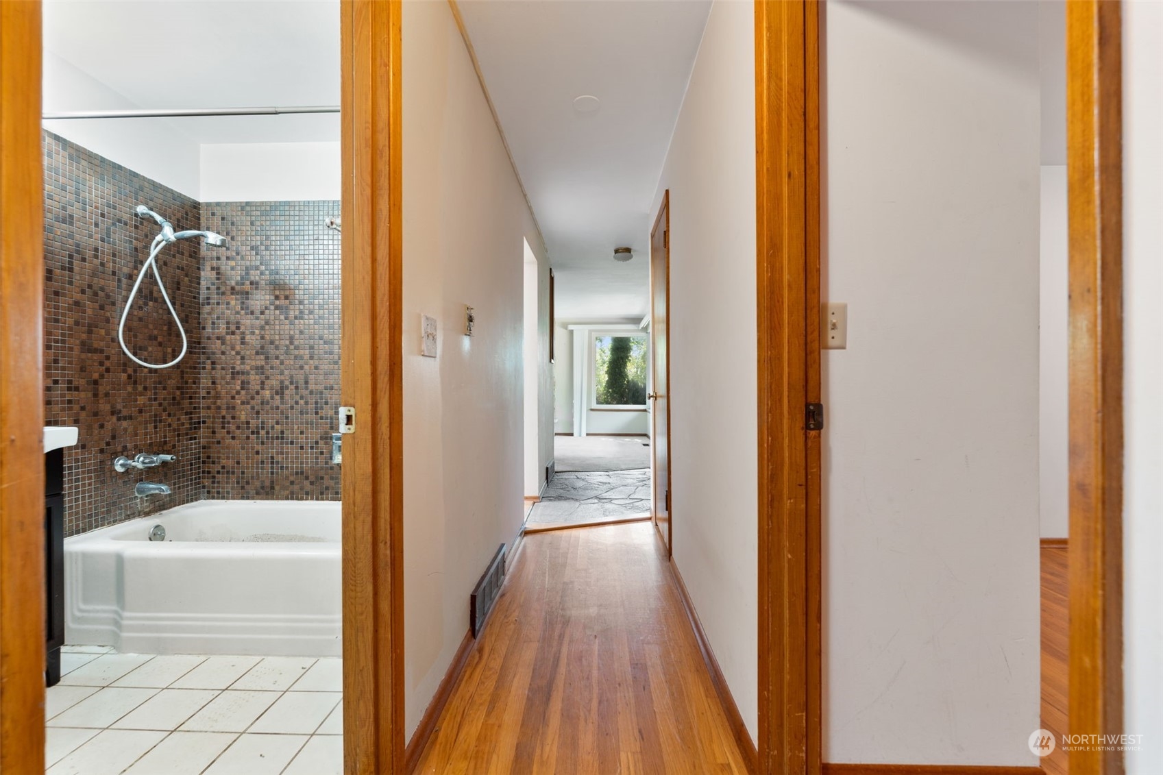 7634 South 112th Street Seattle, WA 98178 - Photo 11 of 26 a bathroom with a glass shower door