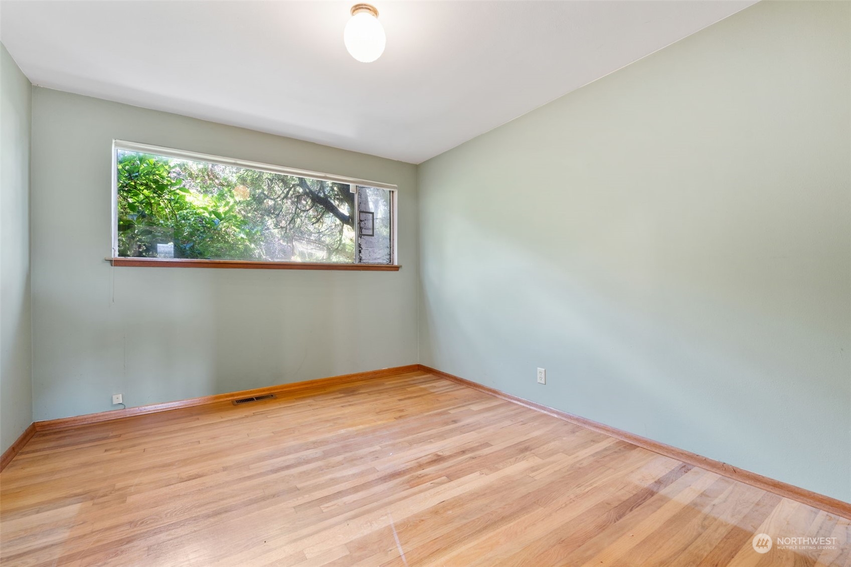 7634 South 112th Street Seattle, WA 98178 - Photo 15 of 26 an empty room with wooden floor and windows