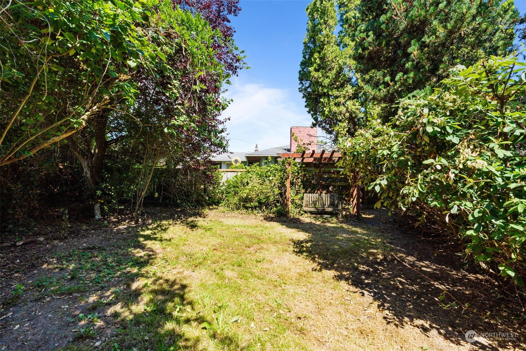 7634 South 112th Street Seattle, WA 98178 - Photo 20 of 26 a view of a yard with plants and trees